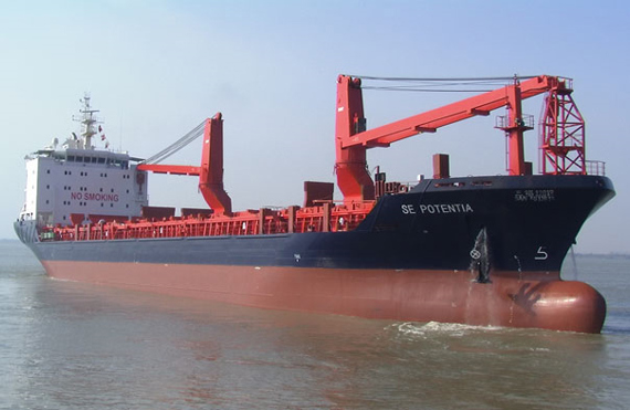 Cargo ship "SE POTENTIA" sailing in calm waters, featuring red cranes.