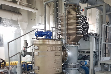 Industrial fluid handling system with pipes, valves, and a DESMI filtration unit.