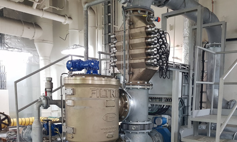 Industrial fluid handling system with pipes, valves, and a DESMI filtration unit.