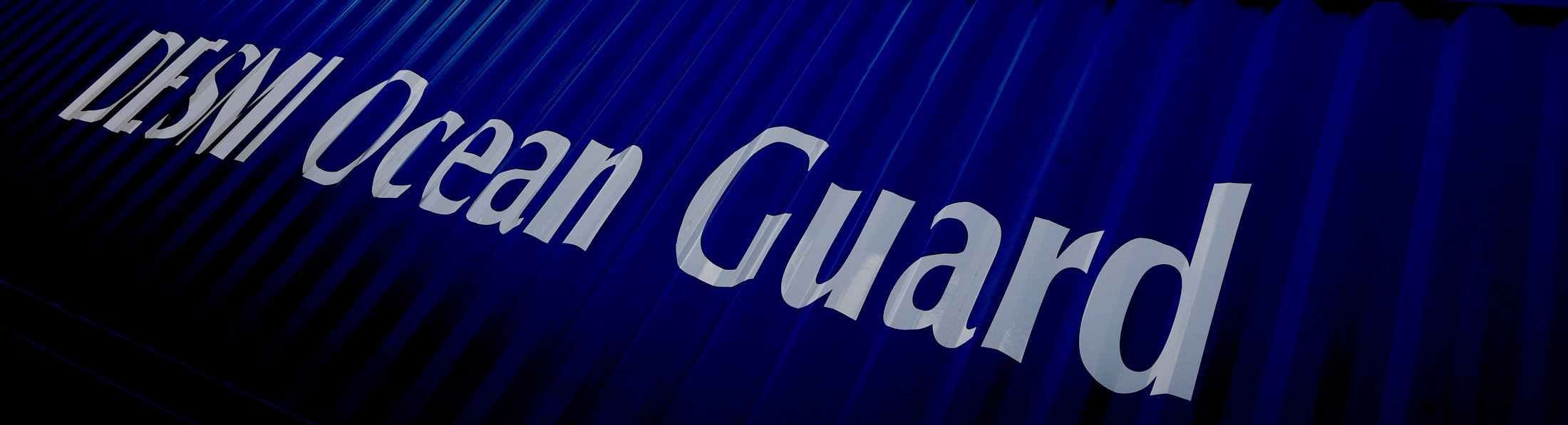 Blue container with "DESMI Ocean Guard" text prominently displayed.