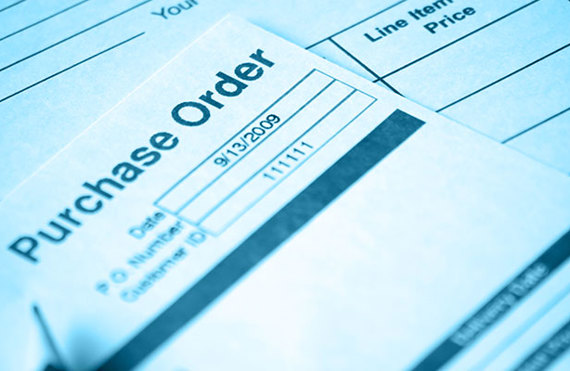 Close-up of a purchase order form with a pen, emphasizing date and details.