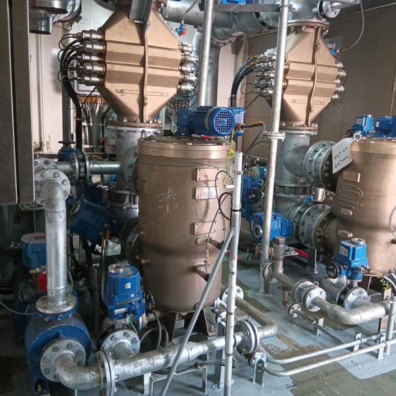 Industrial setup with large pumps and piping, featuring DESMI equipment for fluid handling.