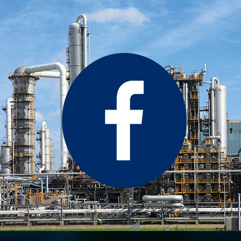 Industrial facility with a large Facebook logo overlay in the foreground.