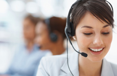 Smiling customer service representative wearing a headset, assisting clients.