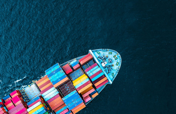Aerial view of a cargo ship with colorful containers at sea.