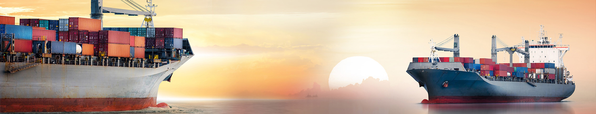 Two cargo ships with containers at sea during a sunset.