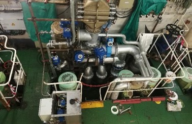 Industrial machinery setup with pipes and equipment for fluid handling.
