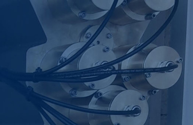 Industrial equipment with wires and connectors, blue background with a checkmark icon.