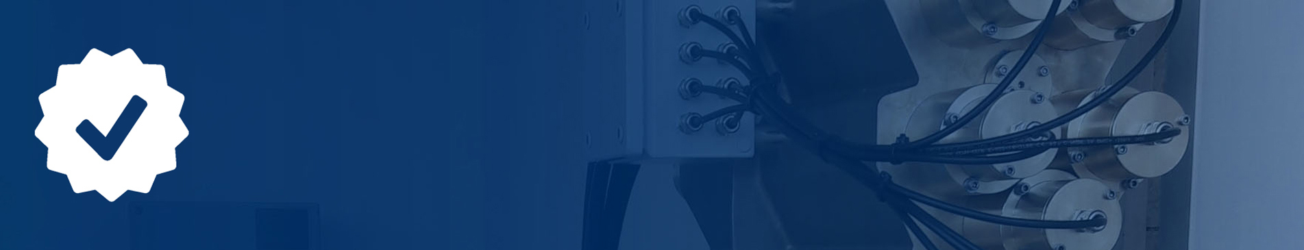 Industrial equipment with wires and connectors, blue background with a checkmark icon.