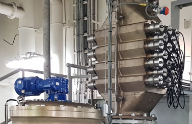 Industrial filtration system with metallic pipes and equipment in a facility.